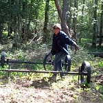 Mies kantaa vankkurin akselia paikoilleen